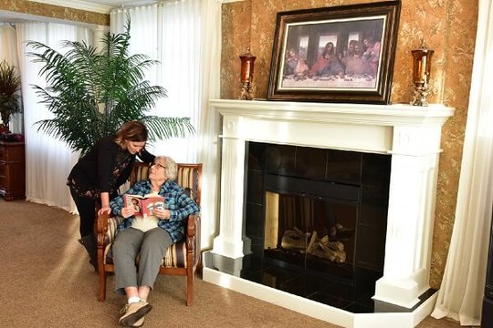 Two women talking near fire place